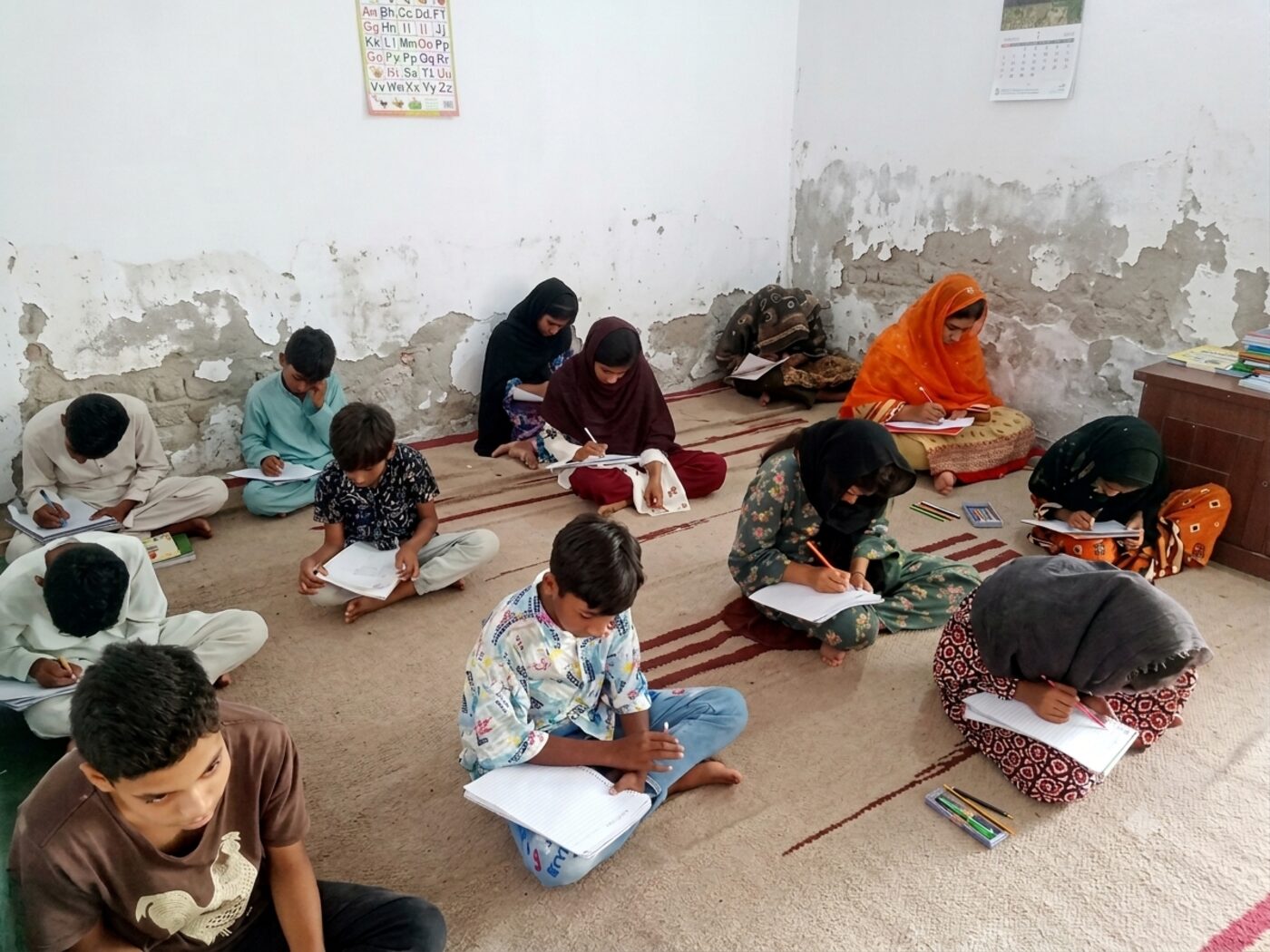 Students at the Universal Truth Education Center writing during a lesson