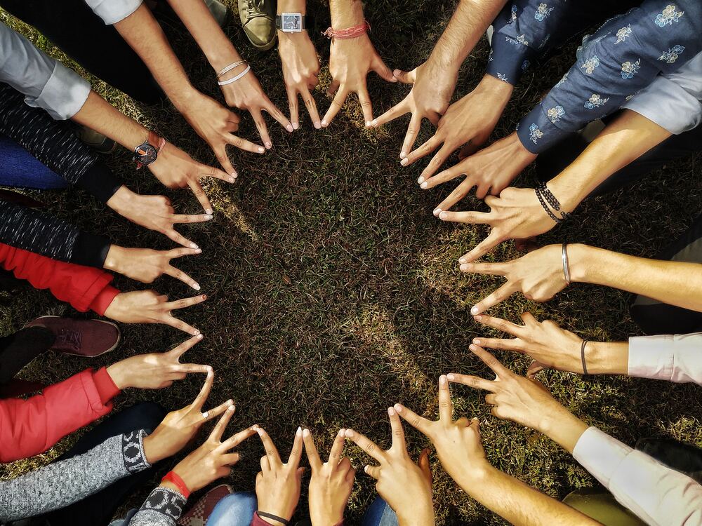 A group of people with hands joined in a circle