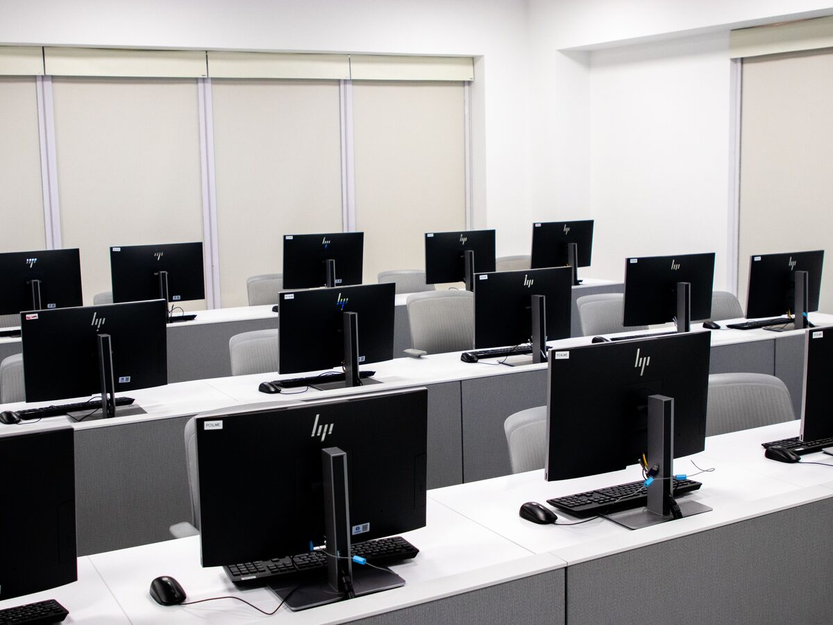 A computer lab with rows of monitors