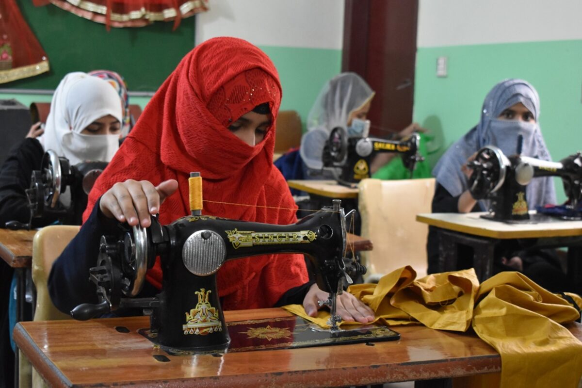 A woman sewing on a machine
